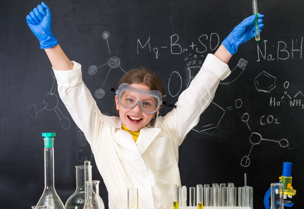 little girl-scientist happy with a chemnical experiment
